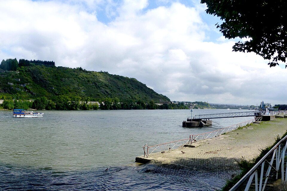 The Rhine river at Andernach, Germany, with a green hillside across the water