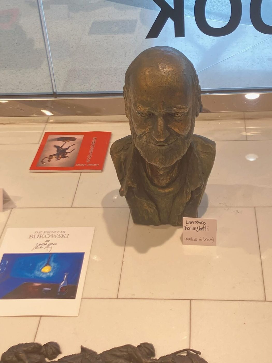 Bronze bust of Lawrence Ferlinghetti on a white table
