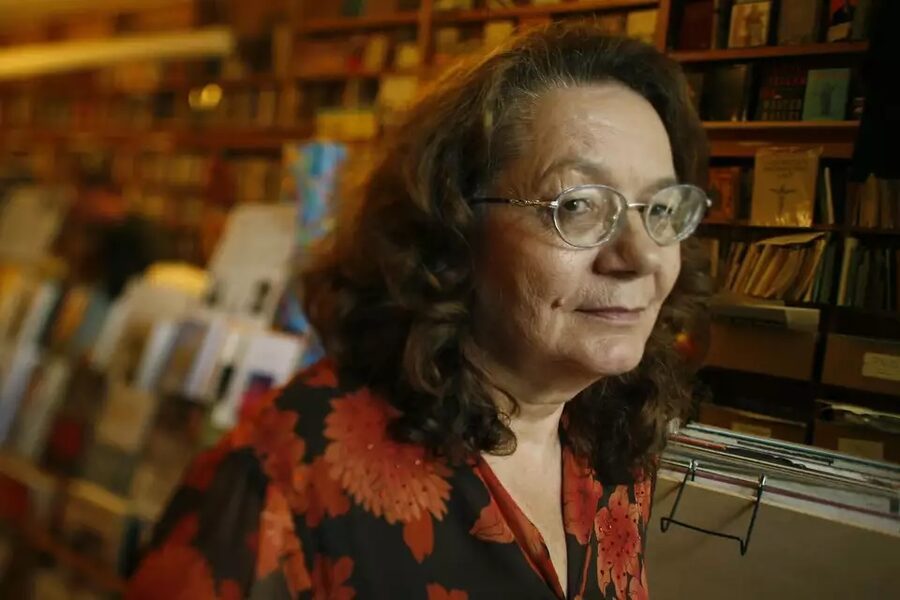 Portrait of Linda King in glasses in a bookstore